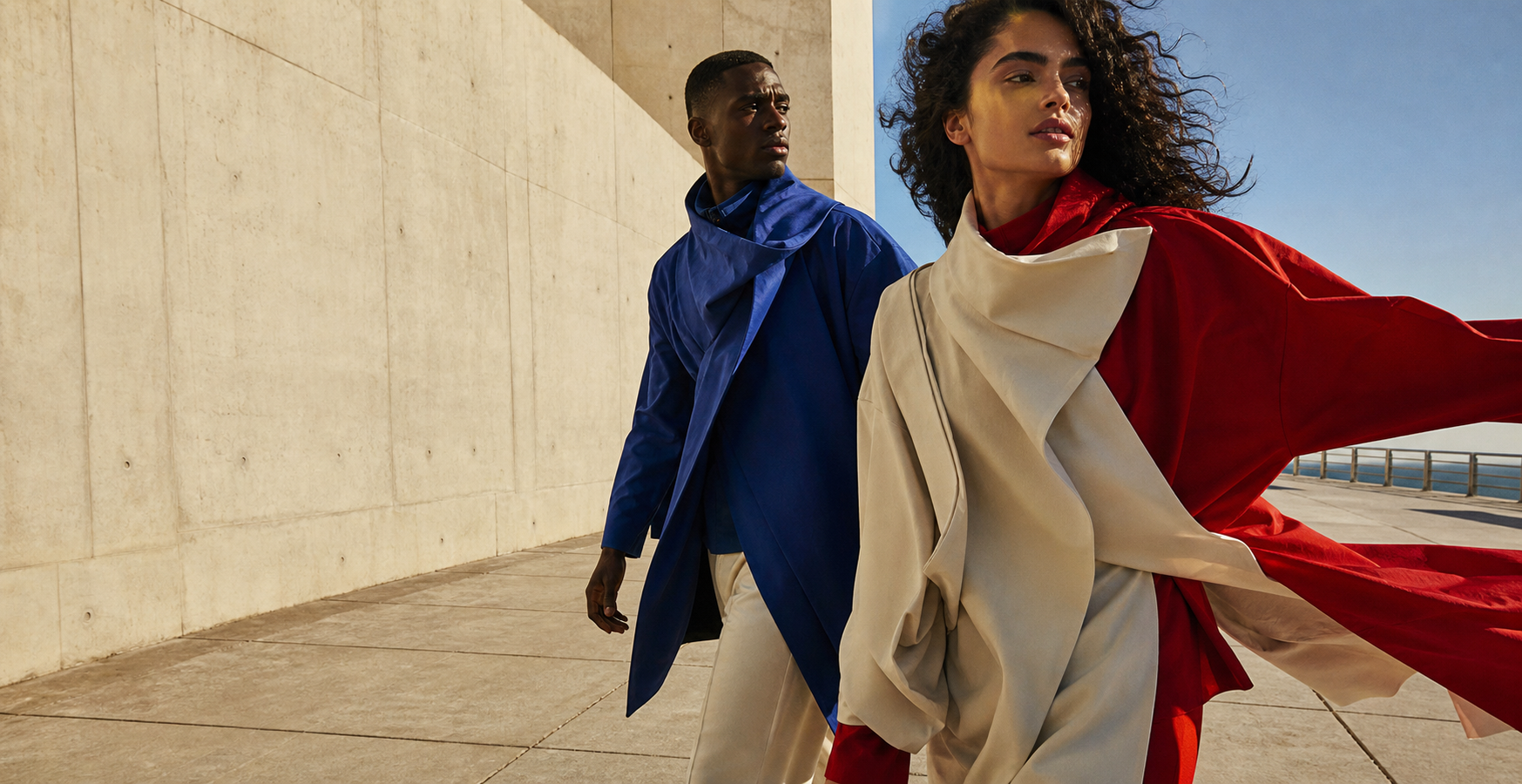 Models in sculptural clothing in motion
